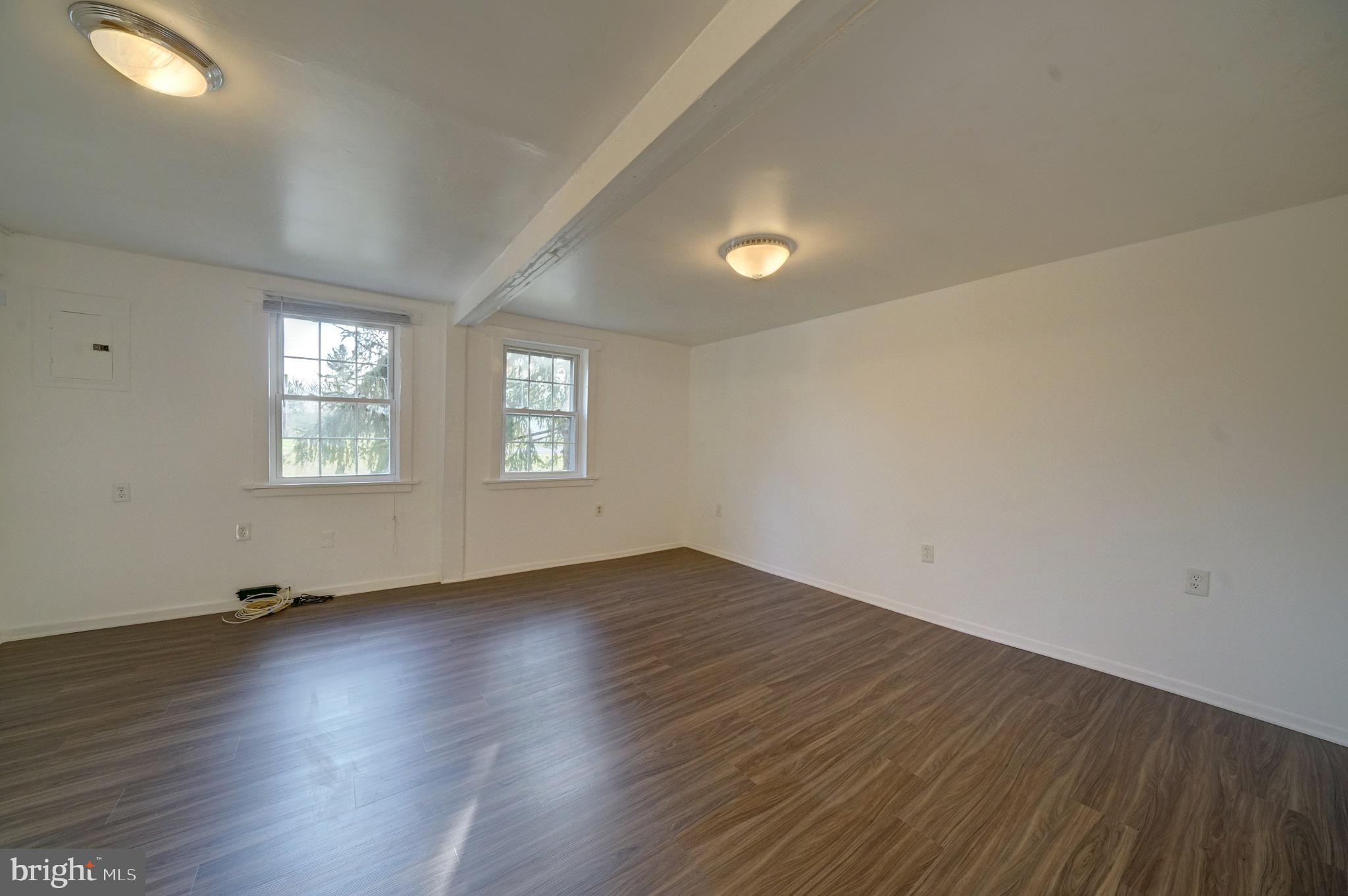 2793 Pfefferkorn Road, Unit D West Friendship, MD 21794 - Photo 8 of 24 an empty room with wooden floor and windows