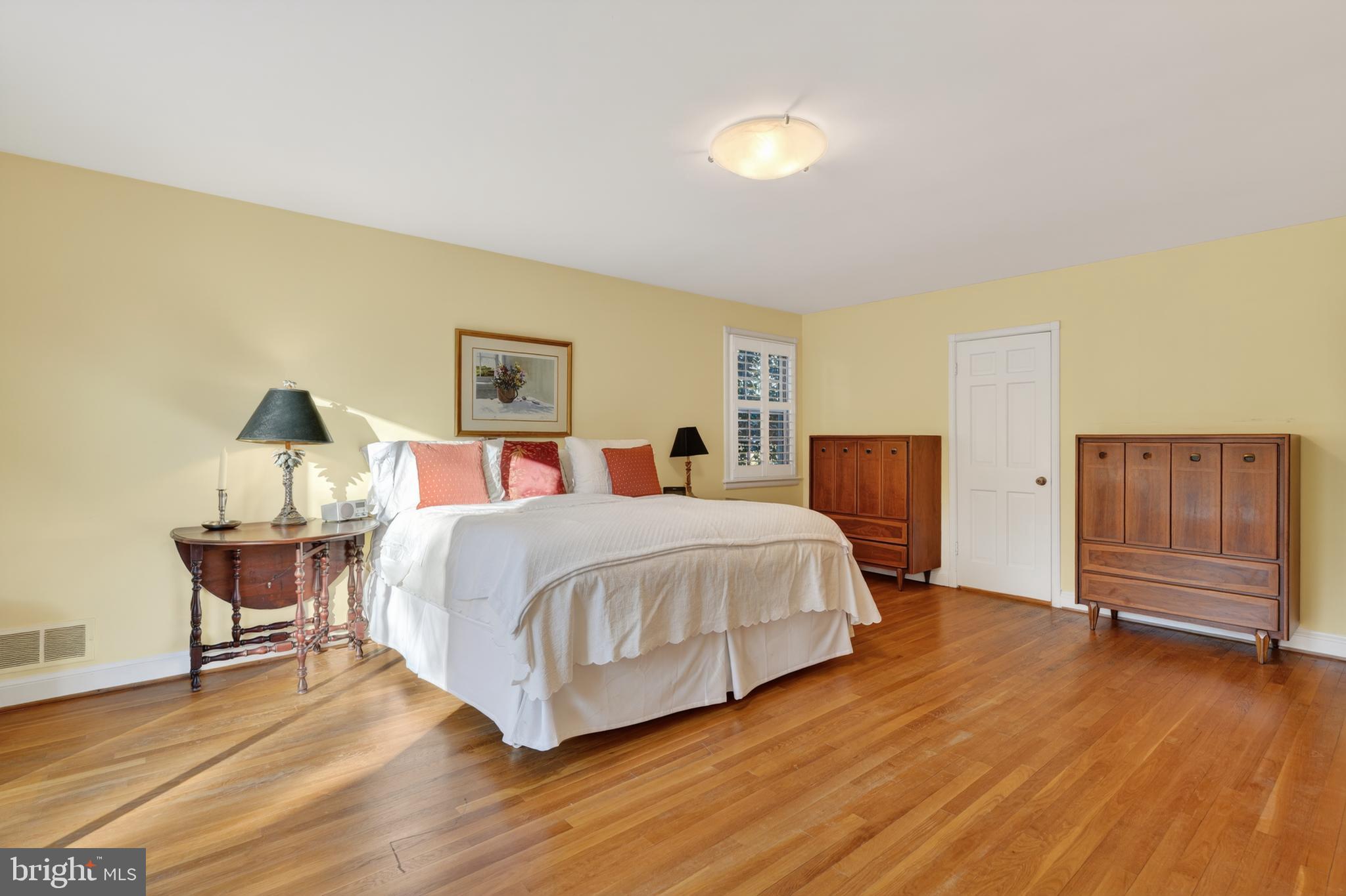 2238 47th Street Northwest Washington, DC 20007 - Photo 19 of 42 a spacious bedroom with a bed and wooden floor