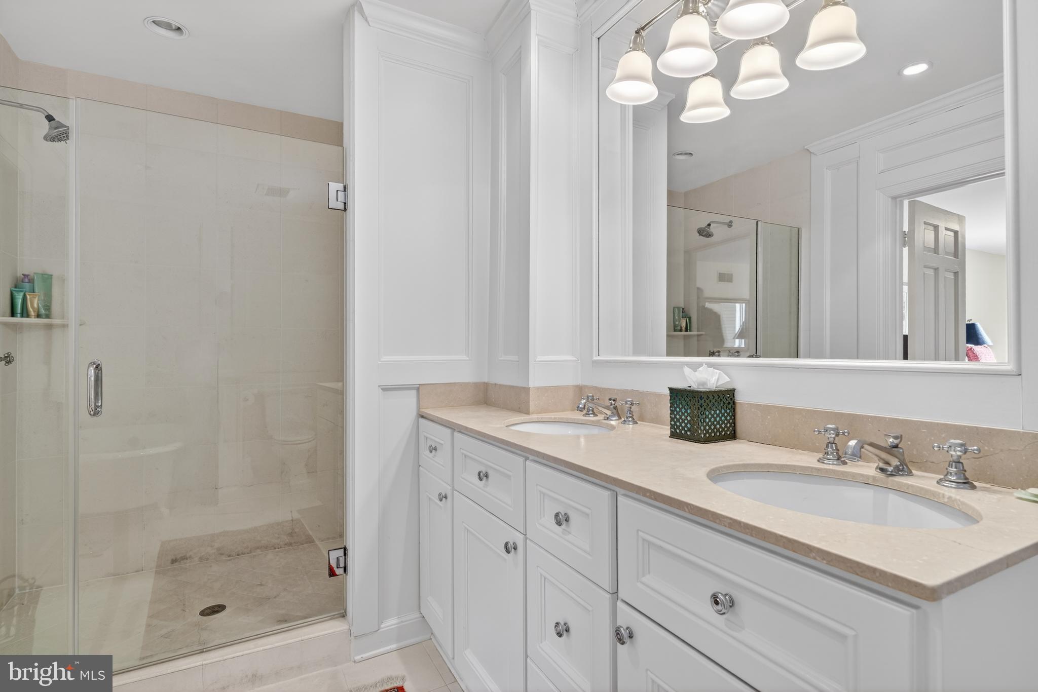 2238 47th Street Northwest Washington, DC 20007 - Photo 21 of 42 a bathroom with a granite countertop sink a mirror and a shower