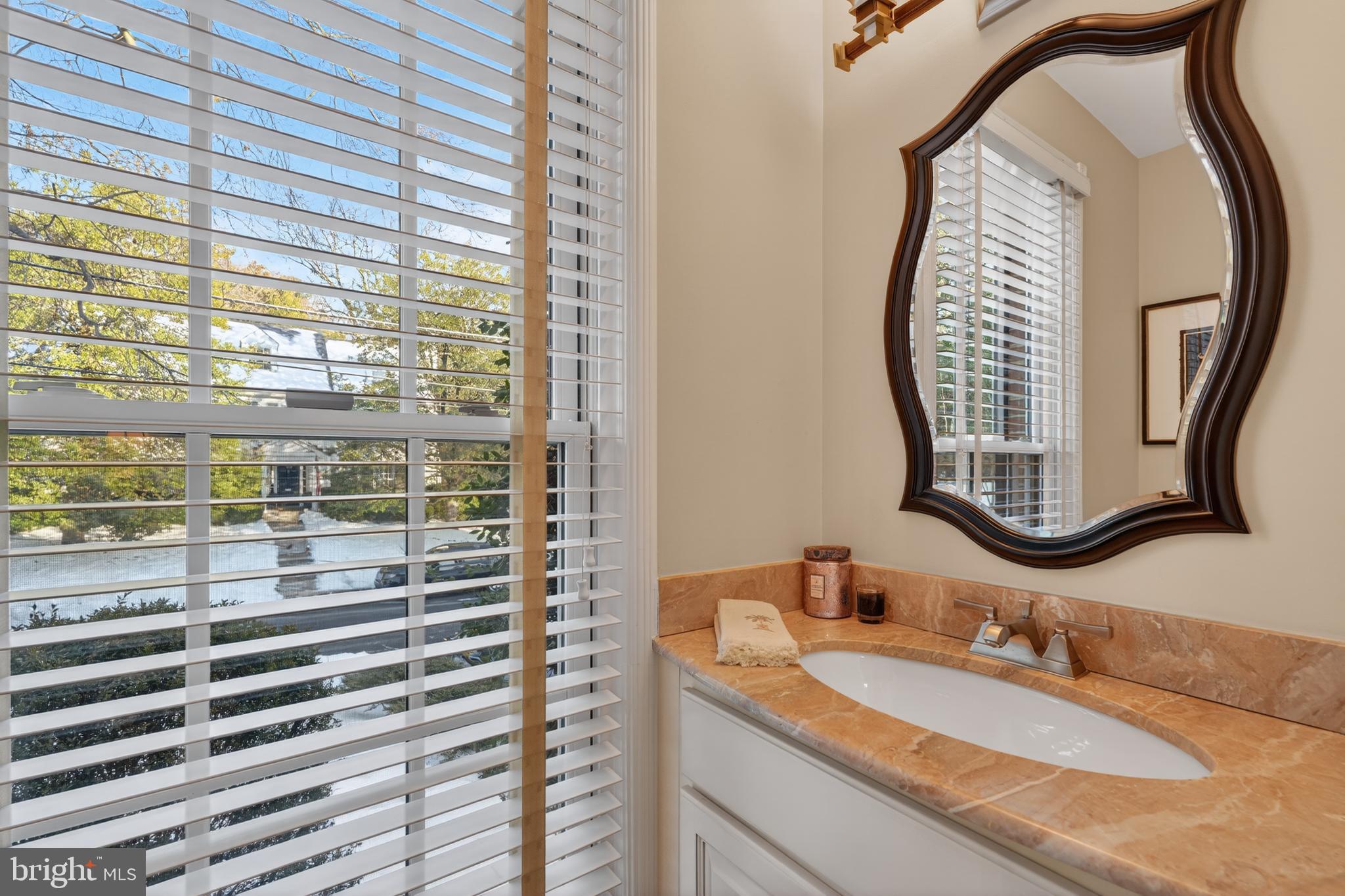 2238 47th Street Northwest Washington, DC 20007 - Photo 29 of 67 a bathroom with a granite countertop sink and a mirror