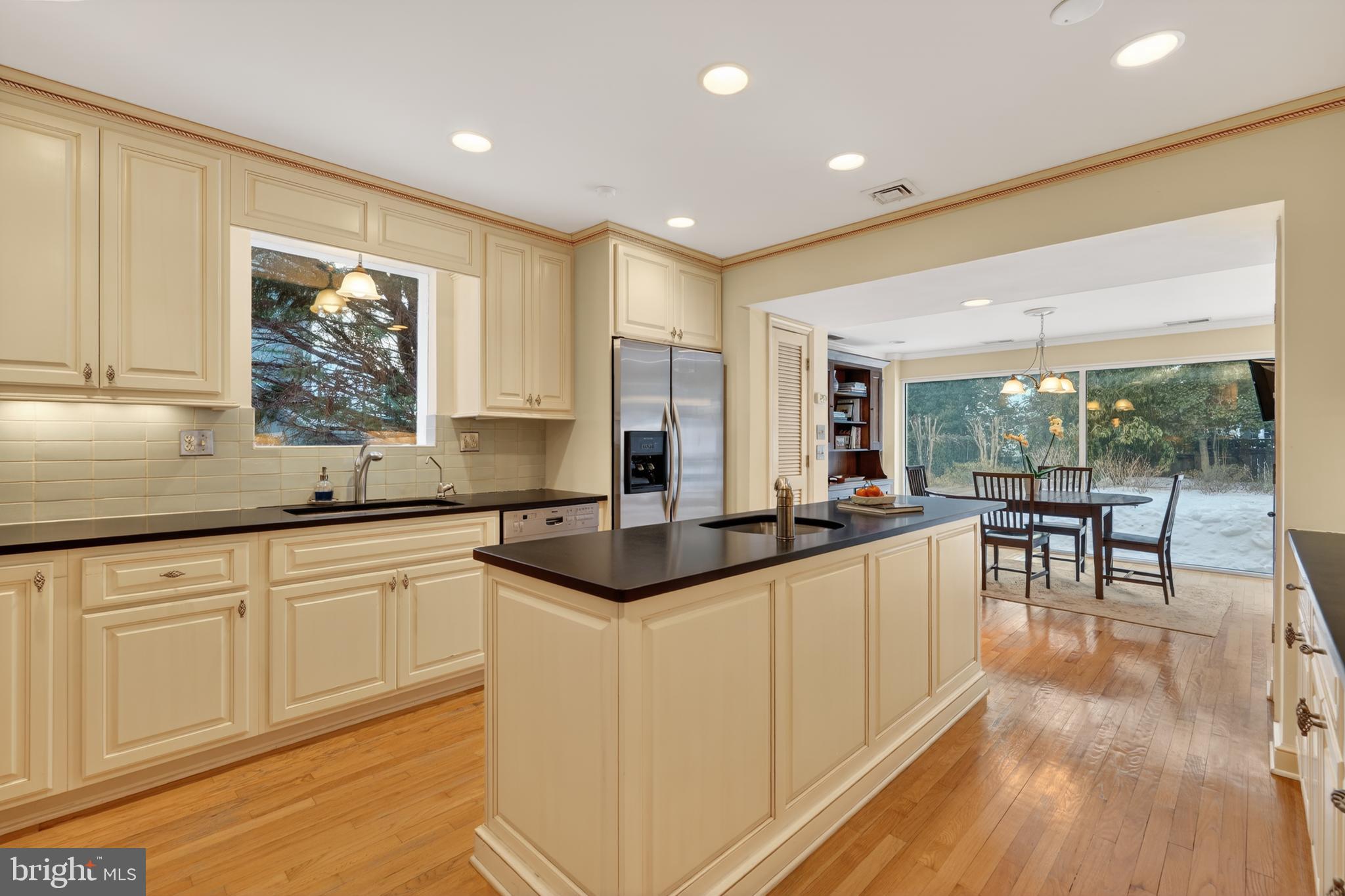 2238 47th Street Northwest Washington, DC 20007 - Photo 6 of 42 a kitchen with granite countertop a stove a sink a dining table and chairs