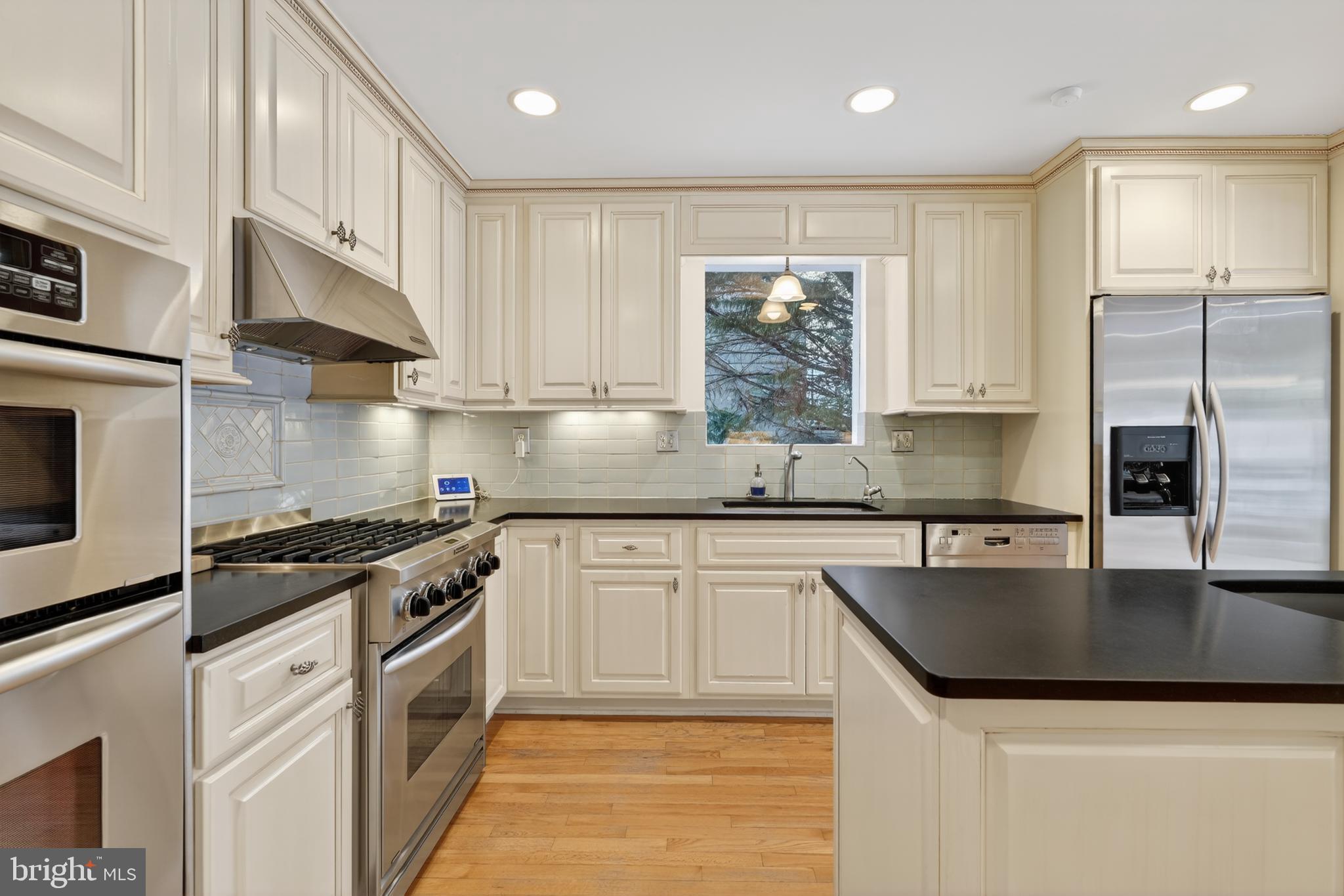 2238 47th Street Northwest Washington, DC 20007 - Photo 7 of 42 a kitchen with a sink stove top oven and refrigerator