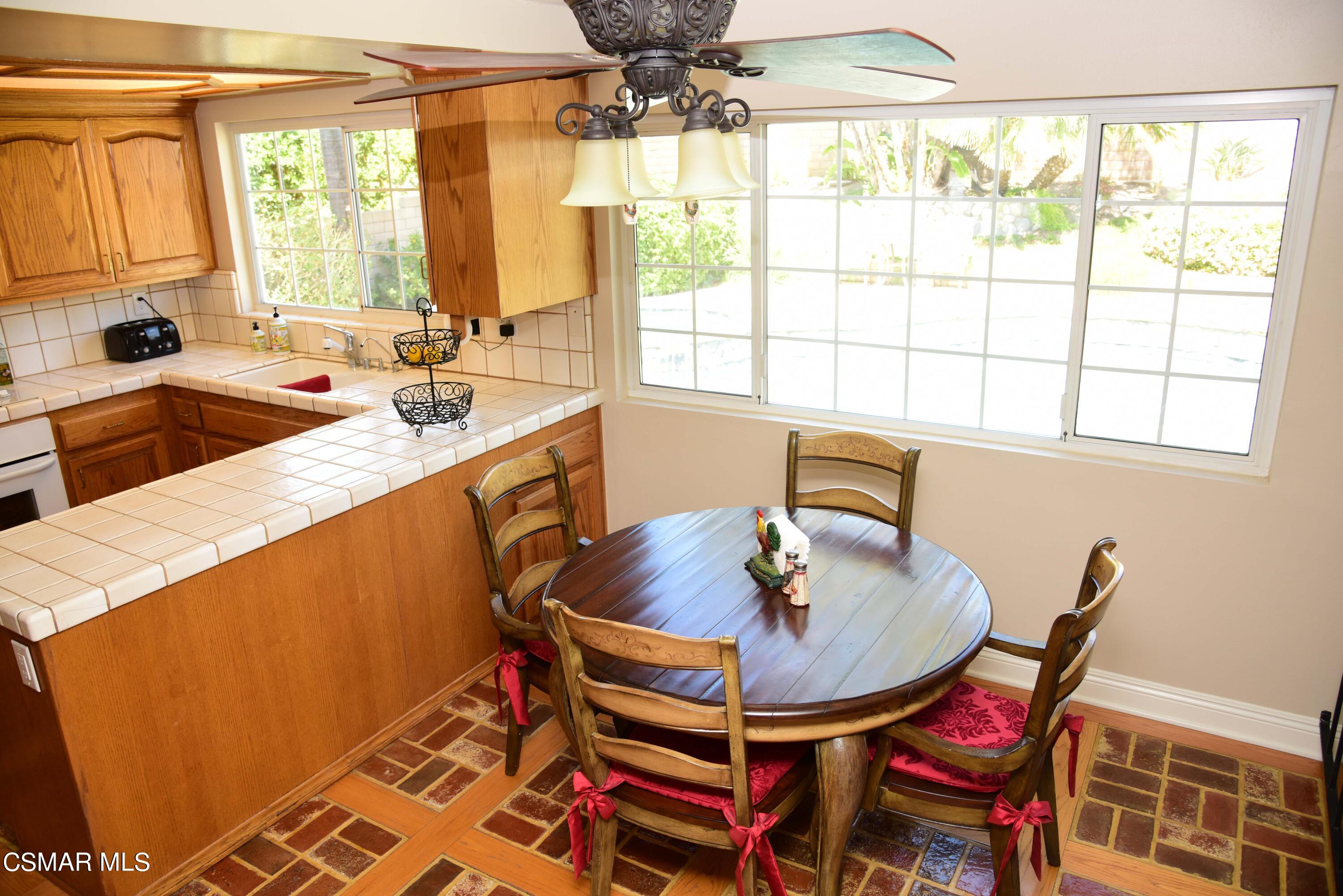 4283 Springfield Street Simi Valley, CA 93063 - Photo 8 of 25 a kitchen with a table chairs and a sink