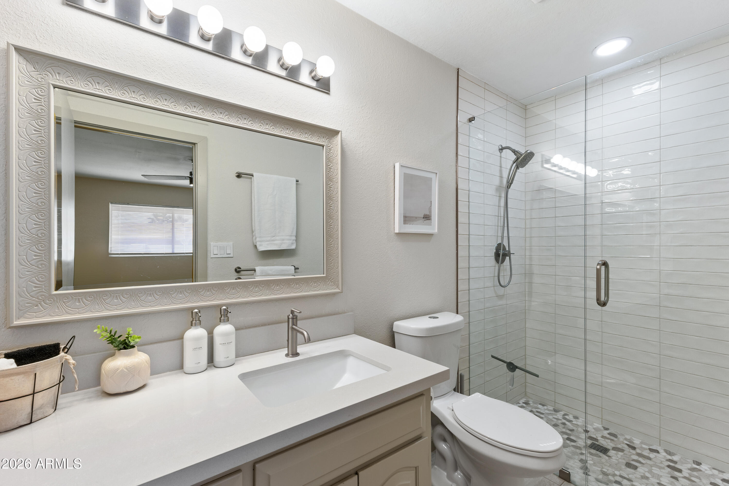 111 South Cholla Street Gilbert, AZ 85233 - Photo 23 of 34 a bathroom with a granite countertop bathtub sink mirror and toilet