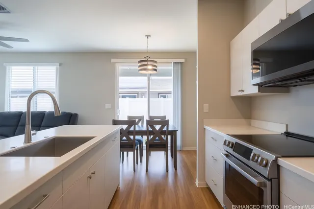 a kitchen with a table chairs a stove and a window