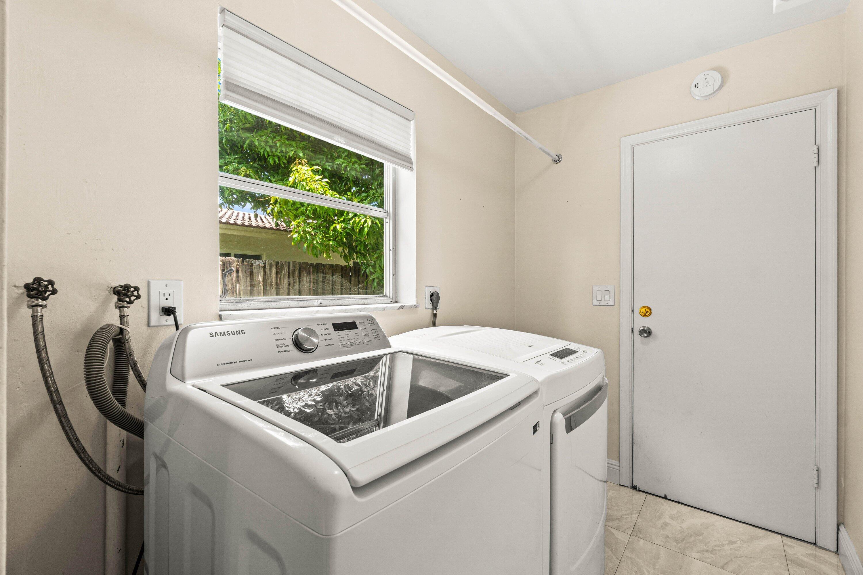 1290 Southwest 8th Street Boca Raton, FL 33486 - Photo 22 of 29 a utility room with dryer and washer