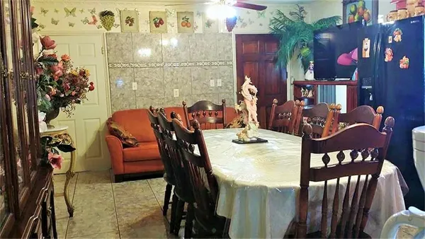 a view of a dining room with furniture and chandelier