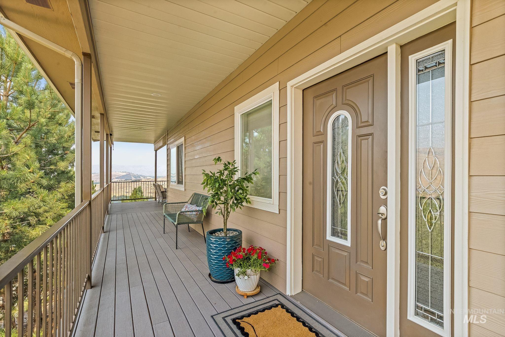 602 Quarry Road Asotin, WA 99402 - Photo 4 of 49 Spacious covered deck featuring composite decking, vertical railing, and a durable exterior door with decorative glass inserts