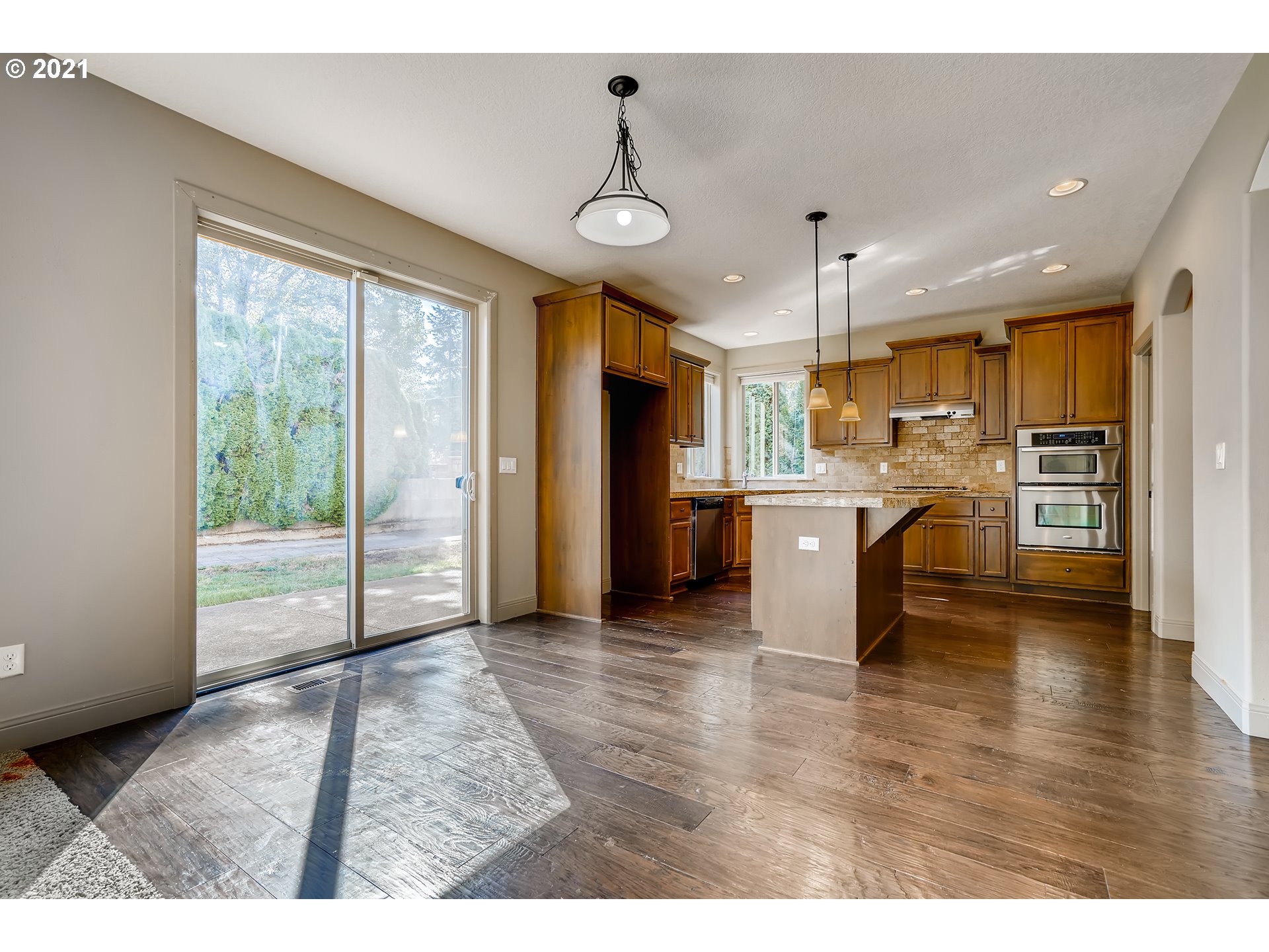18378 Southwest Jeremy Street Beaverton, OR 97007 - Photo 13 of 31 a view of a kitchen with refrigerator and wooden floor