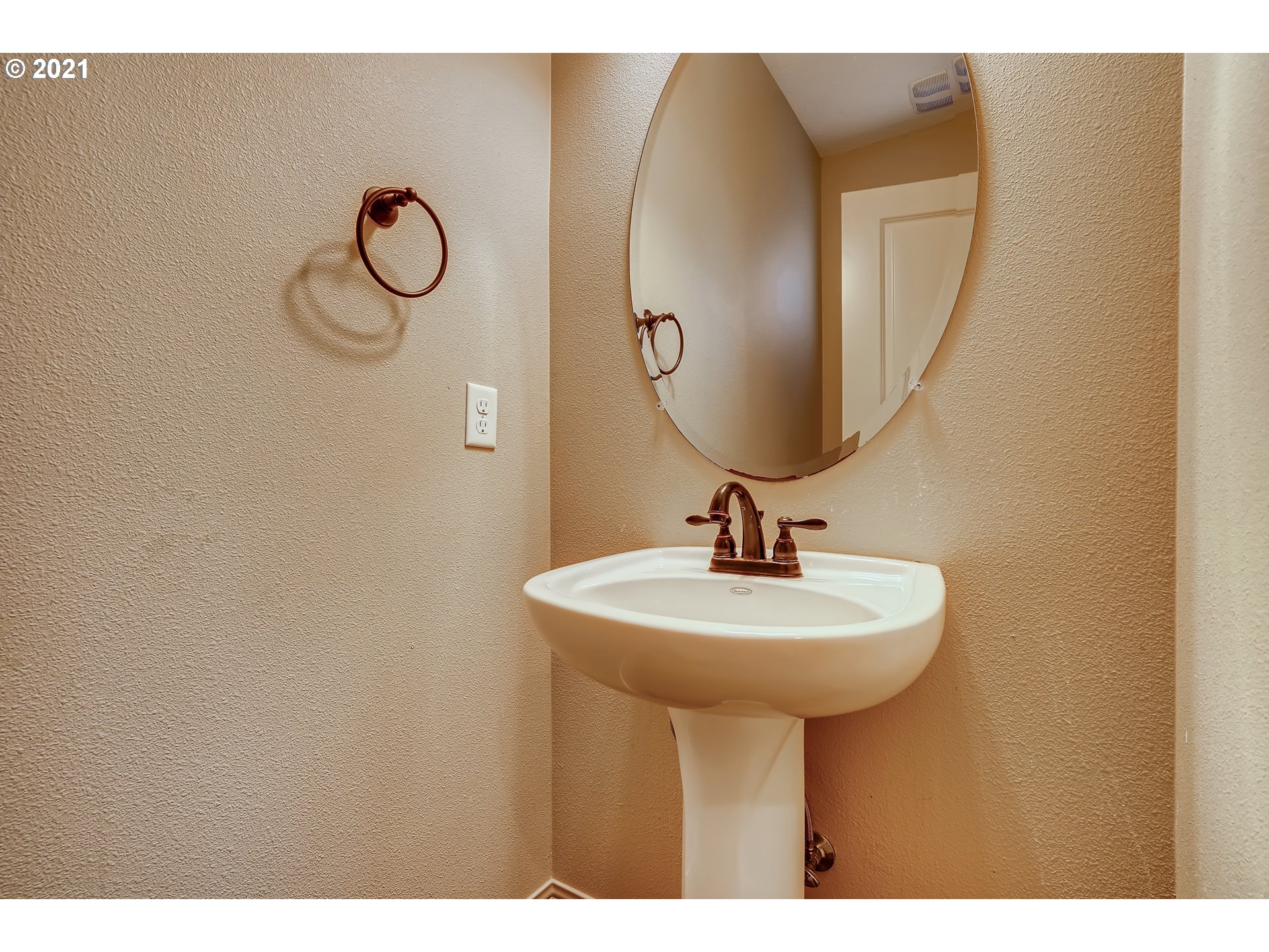 18378 Southwest Jeremy Street Beaverton, OR 97007 - Photo 16 of 31 a bathroom with a sink a mirror and a lamp