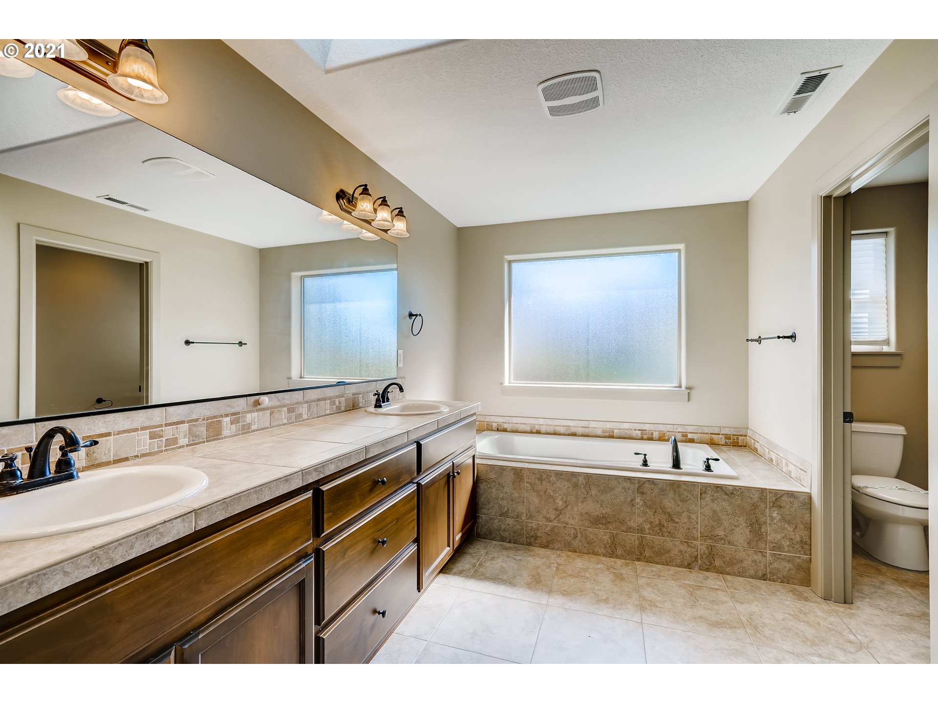18378 Southwest Jeremy Street Beaverton, OR 97007 - Photo 20 of 31 a spacious bathroom with a tub sink and mirror