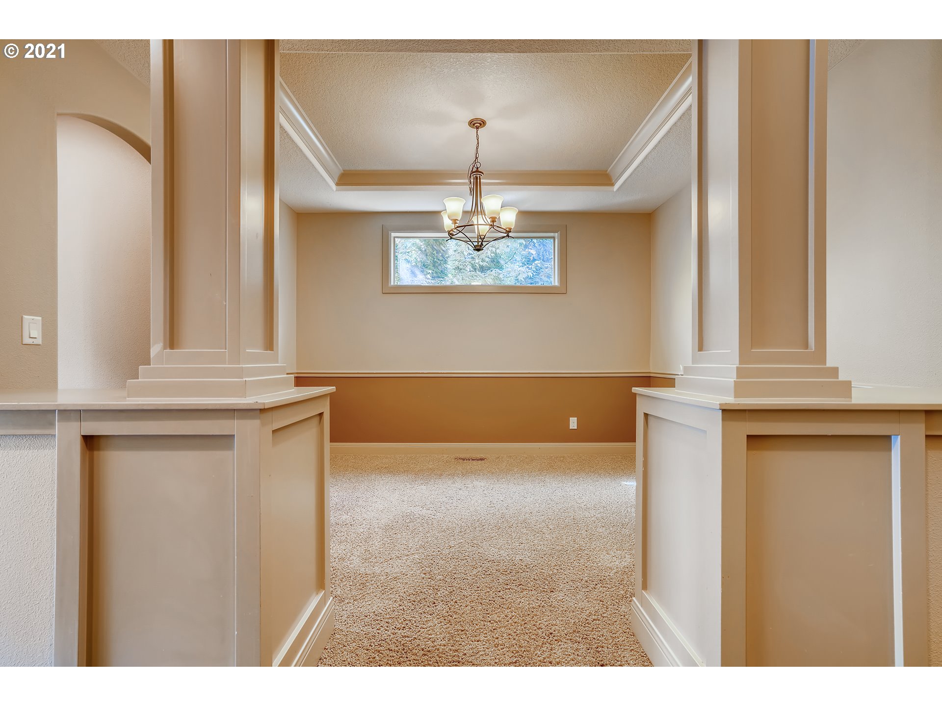 18378 Southwest Jeremy Street Beaverton, OR 97007 - Photo 8 of 31 a view of a hallway with windows and chandelier