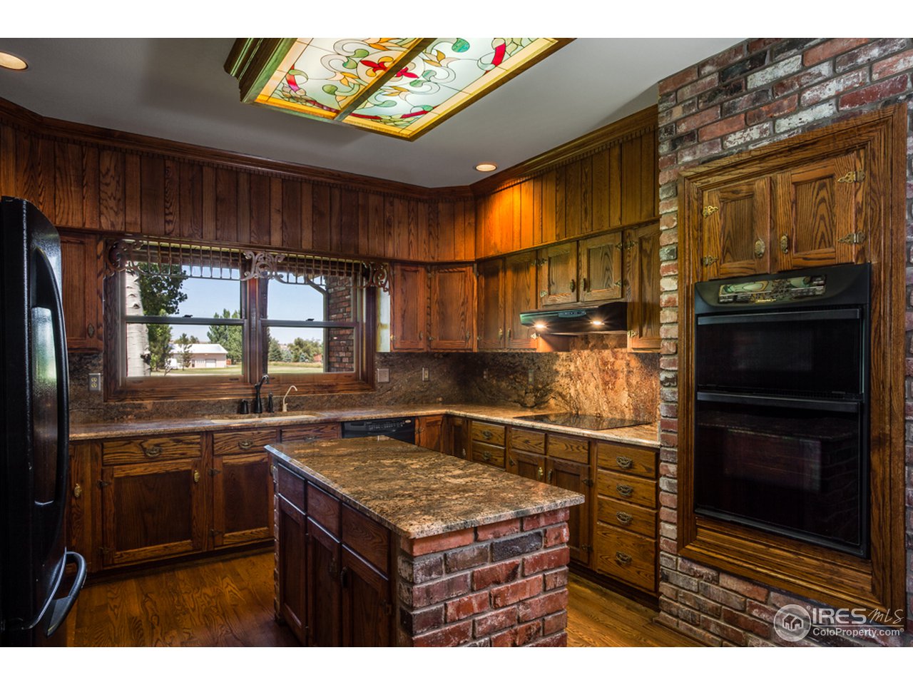 8240 Valmont Road Boulder, CO 80301 - Photo 8 of 17 a kitchen with kitchen island granite countertop a stove and a sink