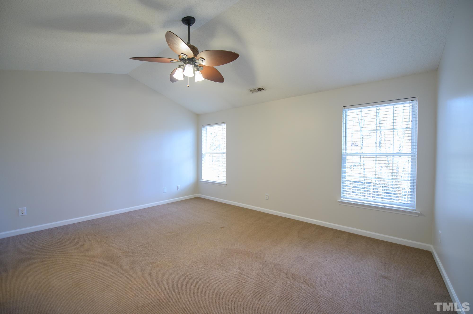 6809 Edwell Court Raleigh, NC 27617 - Photo 13 of 26 an empty room with windows and fan
