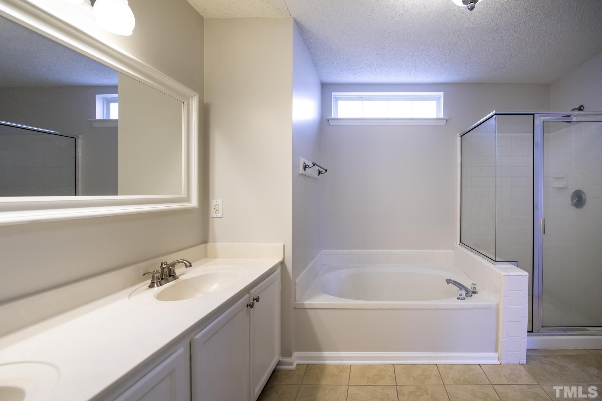 6809 Edwell Court Raleigh, NC 27617 - Photo 15 of 26 a bathroom with a bathtub and a sink