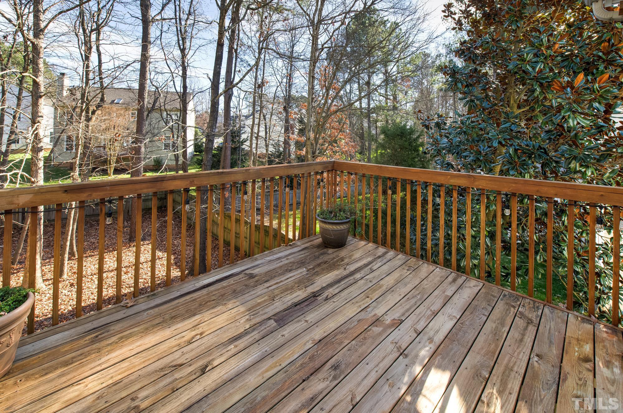 6809 Edwell Court Raleigh, NC 27617 - Photo 22 of 26 a balcony with wooden floor and fence