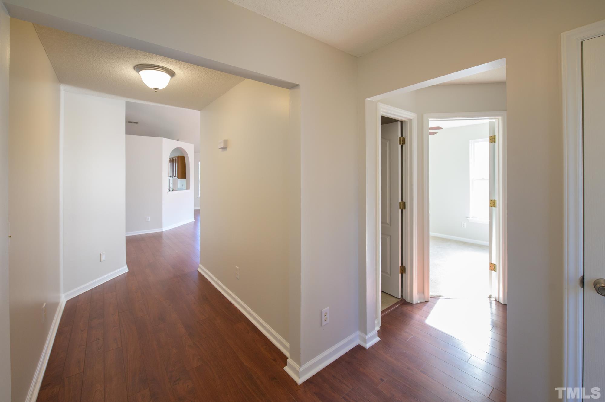6809 Edwell Court Raleigh, NC 27617 - Photo 3 of 26 a view of a hallway with wooden floor