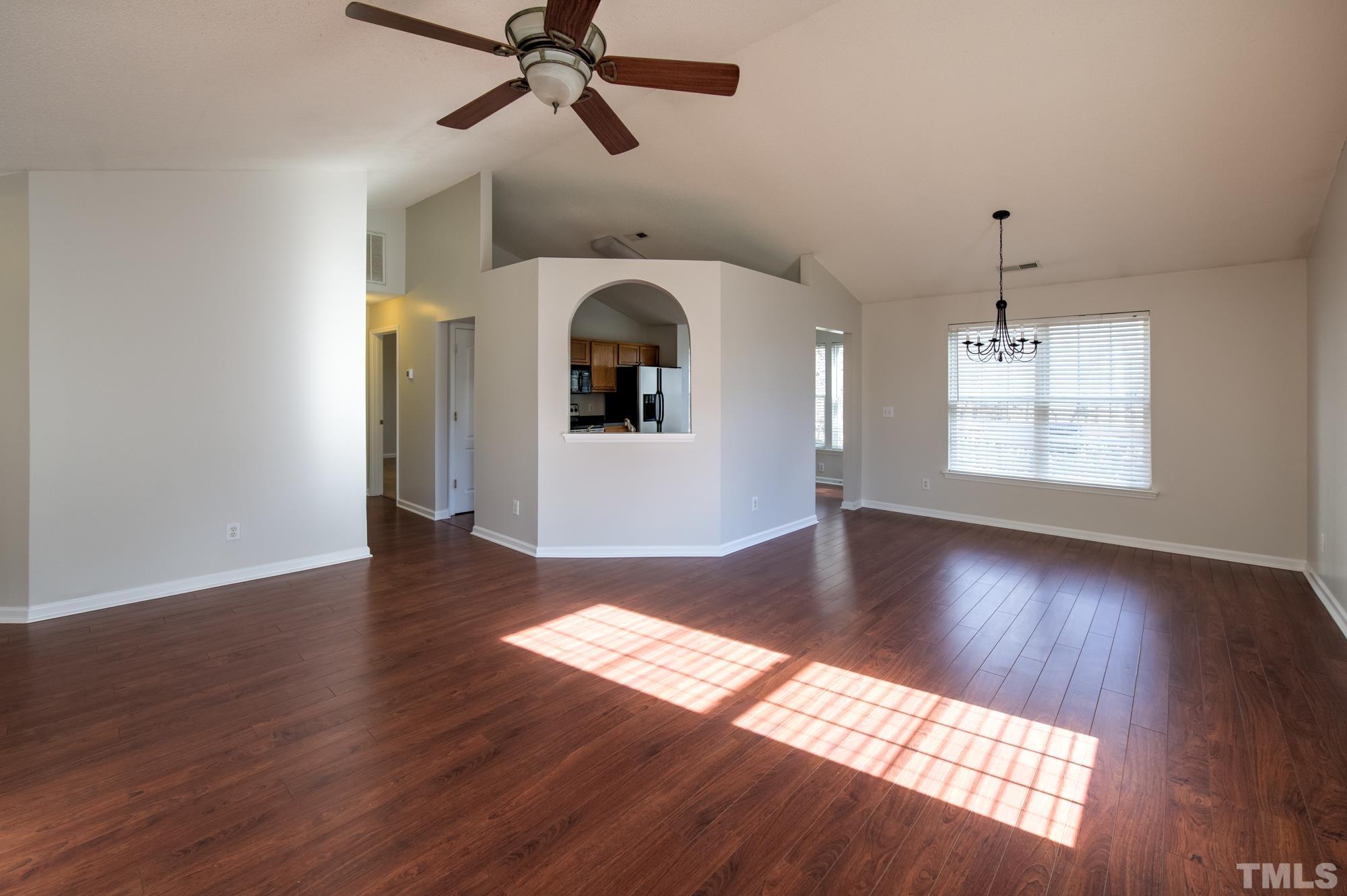 6809 Edwell Court Raleigh, NC 27617 - Photo 6 of 26 a view of an empty room with wooden floor and a window