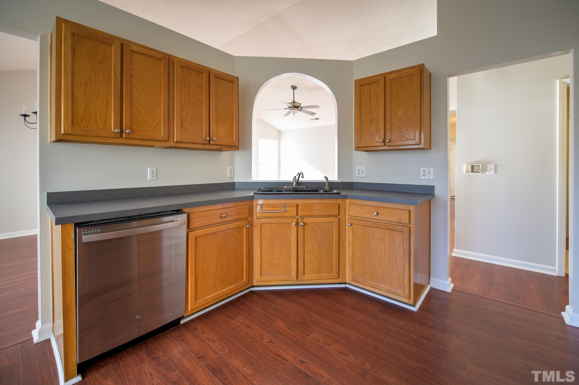 6809 Edwell Court Raleigh, NC 27617 - Photo 10 of 26 a view of a kitchen with wooden floor and cabinets