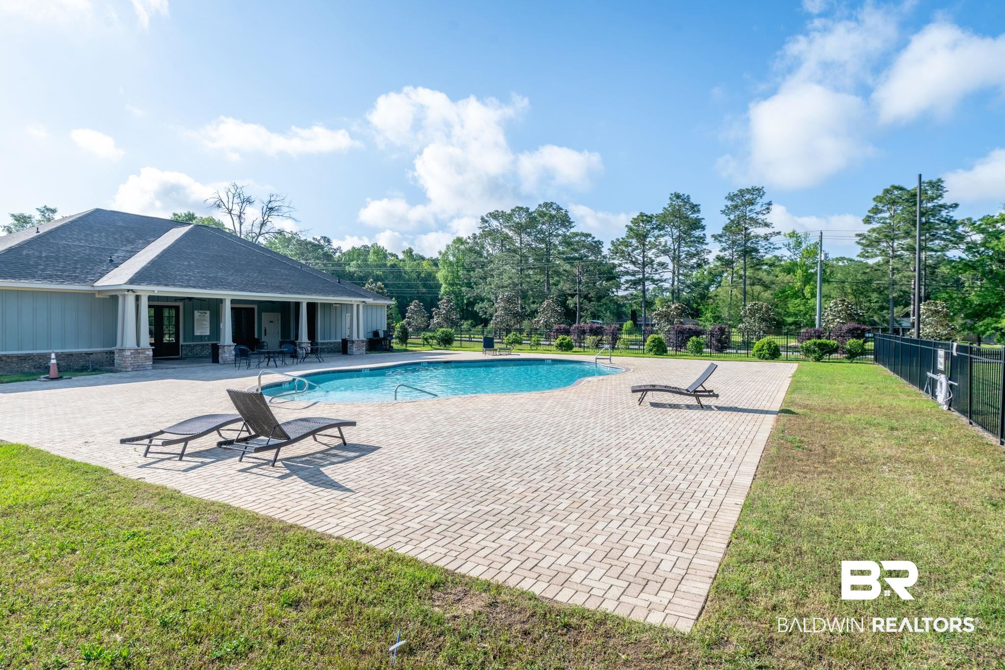 2183 Meadowview Loop Semmes, AL 36575 - Photo 57 of 58 View of swimming pool with patio surround and view of wooded area