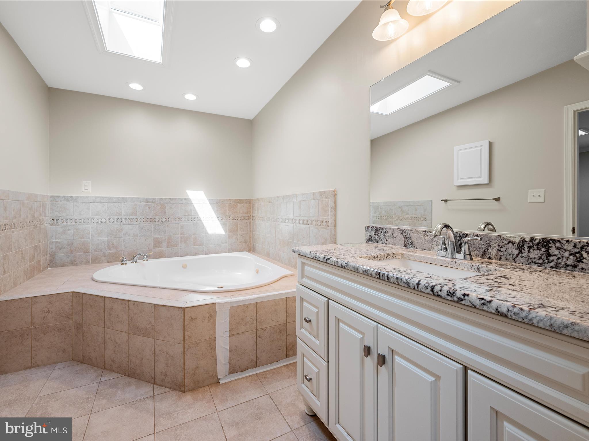 87 Old Waterloo Road Boyce, VA 22620 - Photo 36 of 76 a bathroom with a granite countertop sink a toilet and a mirror