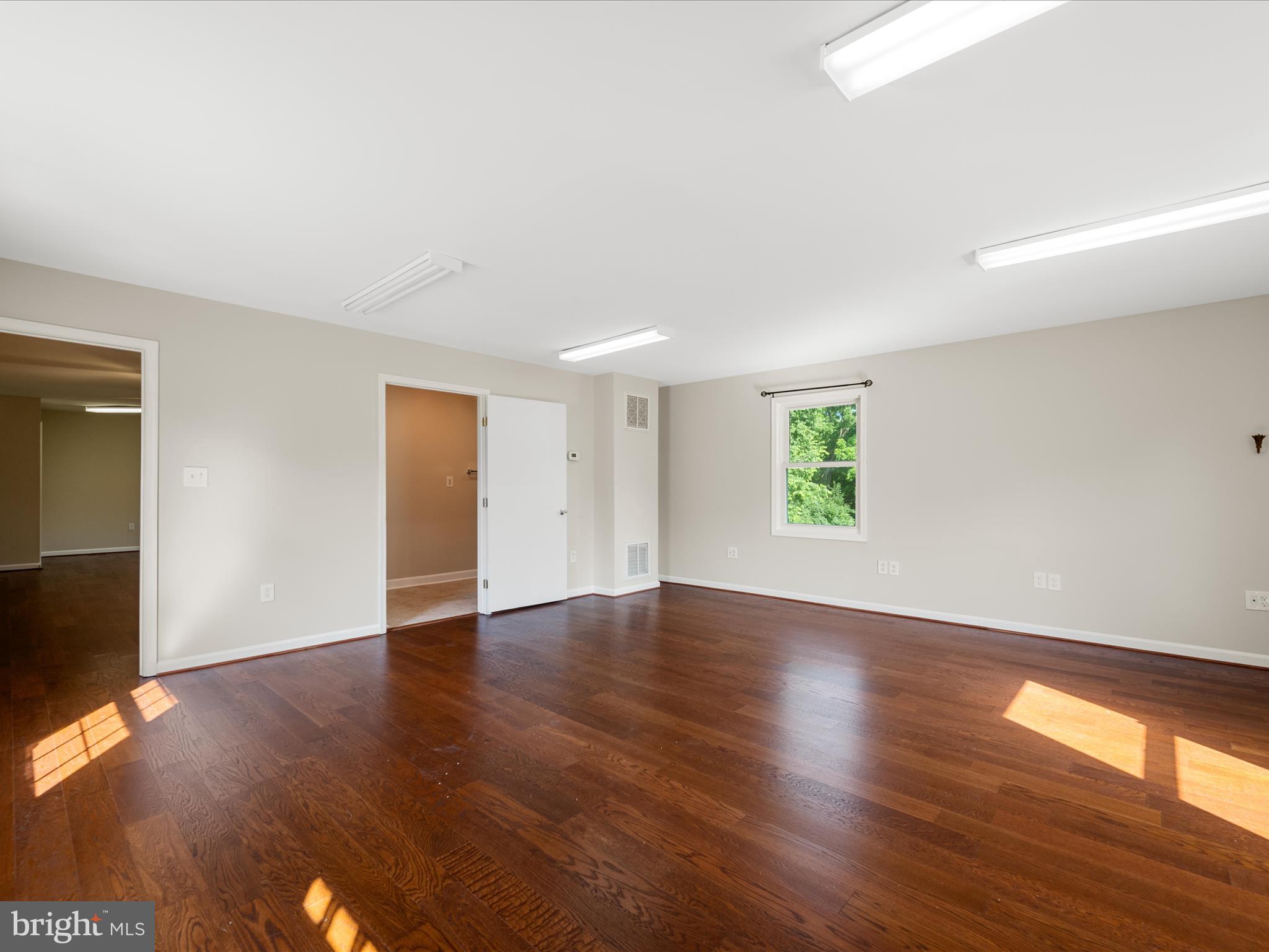 87 Old Waterloo Road Boyce, VA 22620 - Photo 49 of 76 an empty room with wooden floor and windows