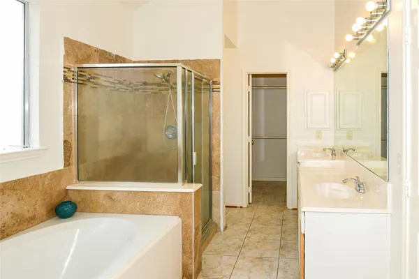 a bathroom with a bathtub and a shower
