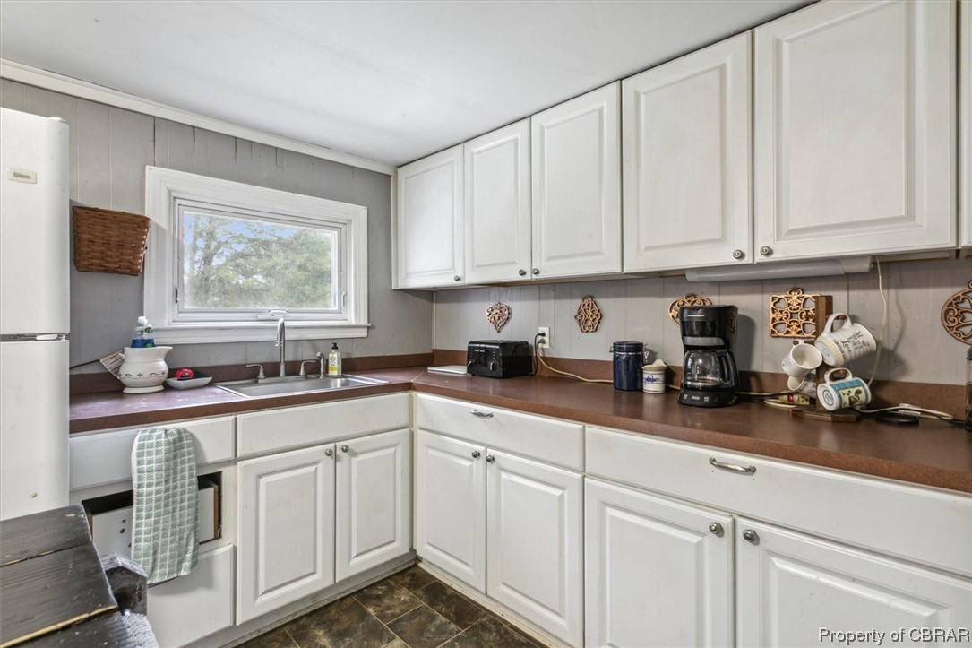 299 Greene Road Mathews, VA 23109 - Photo 16 of 40 a kitchen with stainless steel appliances granite countertop white cabinets sink and a window