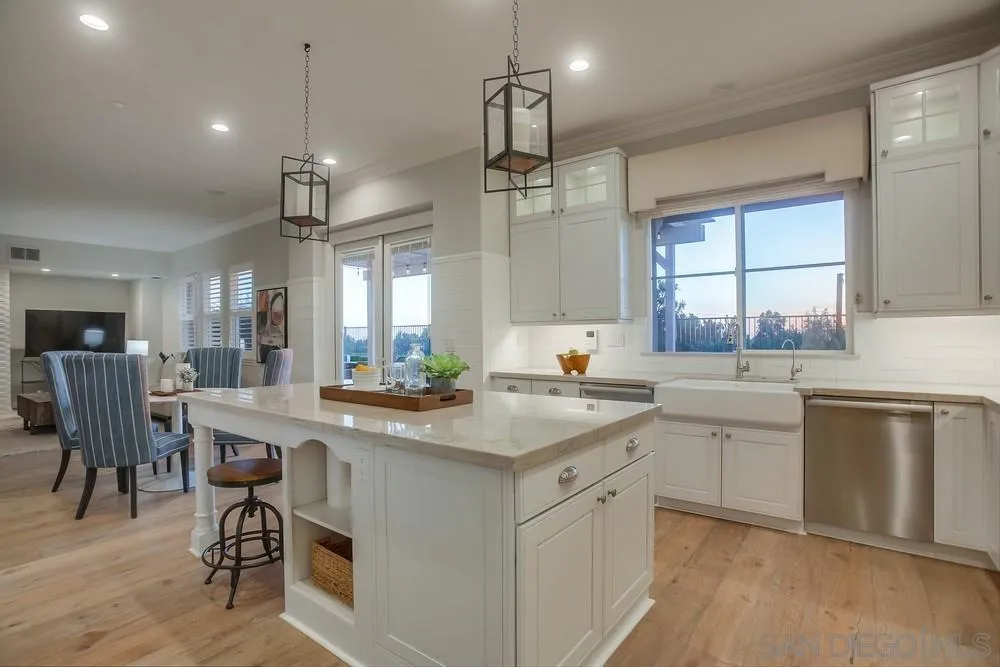 1463 Paseo De Las Flores Encinitas, CA 92024 - Photo 12 of 28 a kitchen with a white cabinets and chairs in it