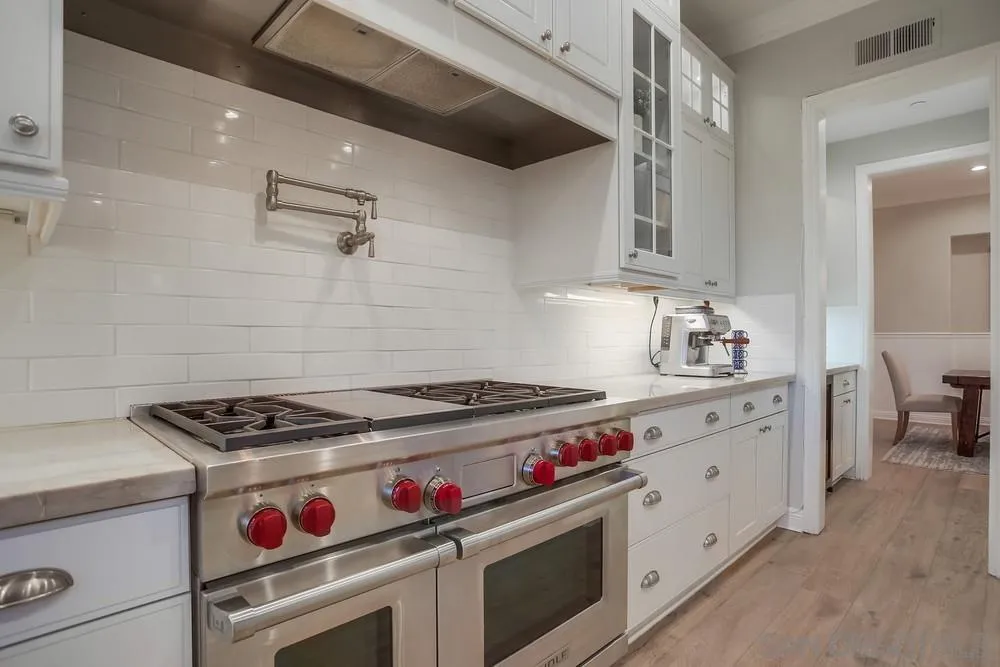 1463 Paseo De Las Flores Encinitas, CA 92024 - Photo 14 of 28 a kitchen with granite countertop a stove and a sink