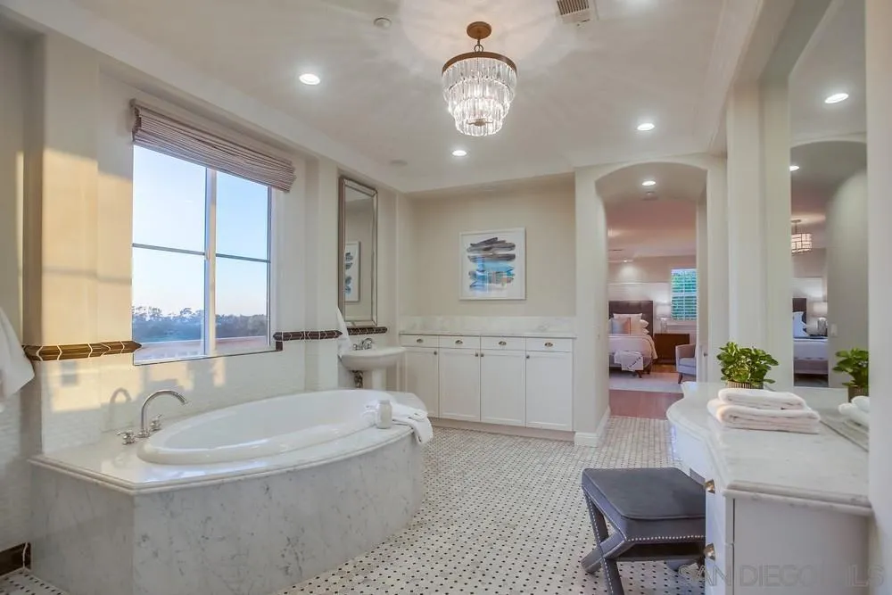 1463 Paseo De Las Flores Encinitas, CA 92024 - Photo 25 of 28 a spacious bathroom with a large tub sink and mirror