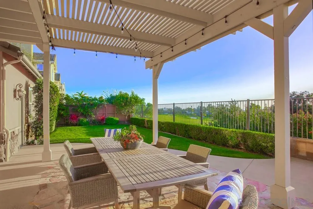 1463 Paseo De Las Flores Encinitas, CA 92024 - Photo 5 of 28 a view of a patio with a table chairs and a backyard