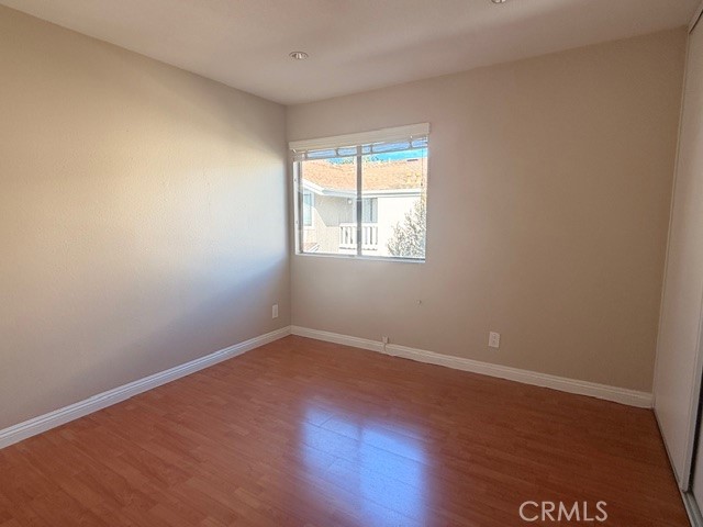 217 Tarocco Irvine, CA 92618 - Photo 10 of 13 an empty room with wooden floor and windows