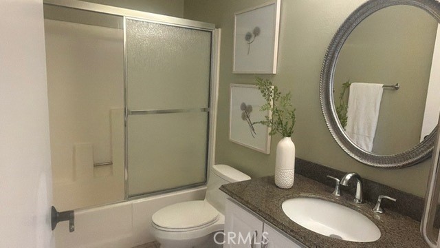 217 Tarocco Irvine, CA 92618 - Photo 11 of 13 a bathroom with a granite countertop sink toilet and shower