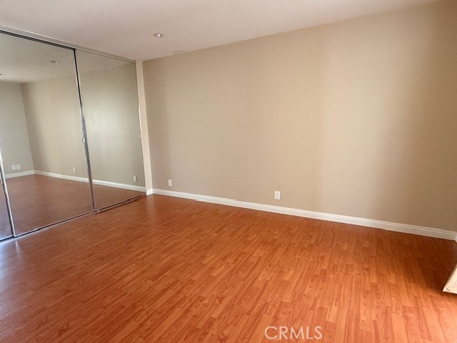 217 Tarocco Irvine, CA 92618 - Photo 8 of 13 a view of an empty room with wooden floor