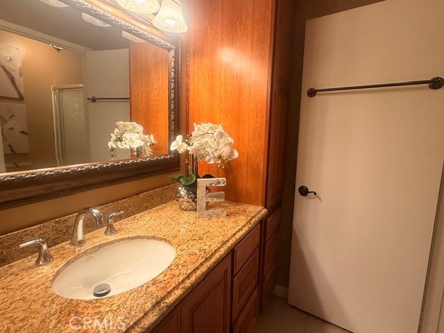 217 Tarocco Irvine, CA 92618 - Photo 9 of 13 a bathroom with a granite countertop sink and a mirror
