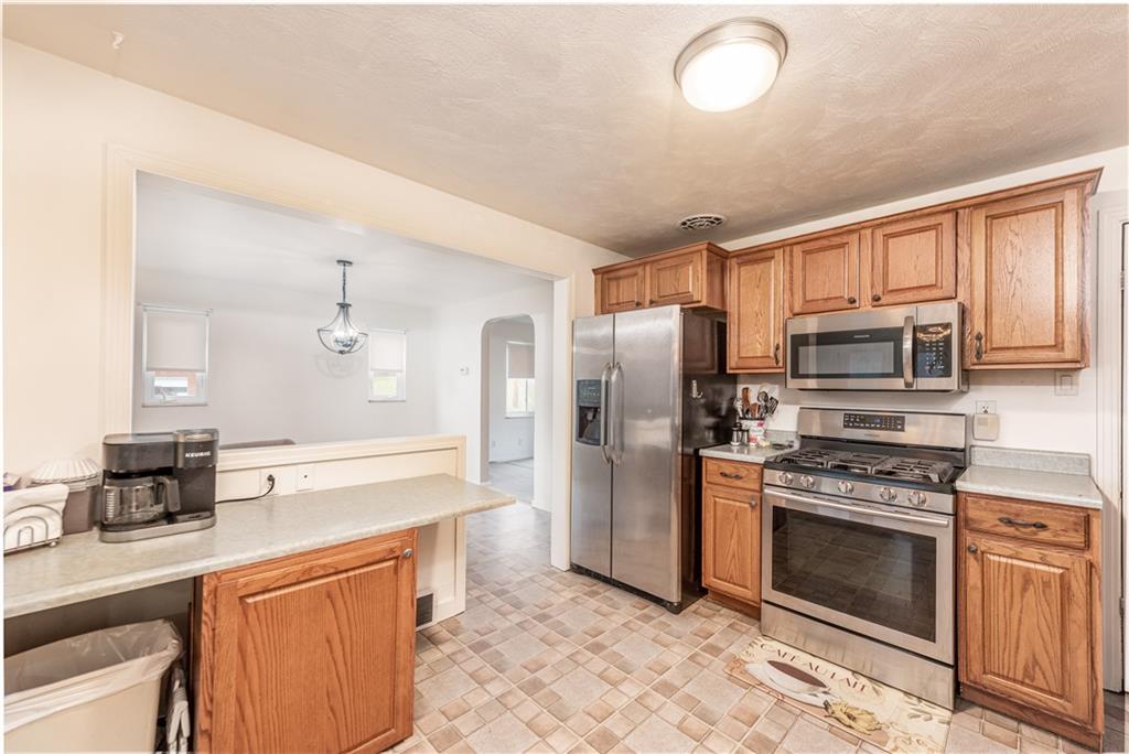 340 Spring Valley Road Pittsburgh, PA 15243 - Photo 12 of 44 a kitchen with stainless steel appliances a stove a sink and a refrigerator