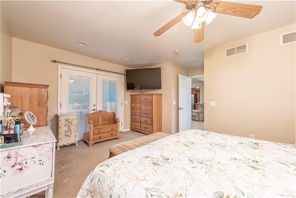 340 Spring Valley Road Pittsburgh, PA 15243 - Photo 23 of 44 a bedroom with a large bed and a chandelier
