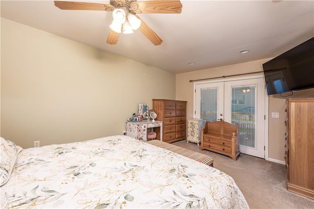 340 Spring Valley Road Pittsburgh, PA 15243 - Photo 24 of 44 a bedroom with a bed dresser and a flat screen tv
