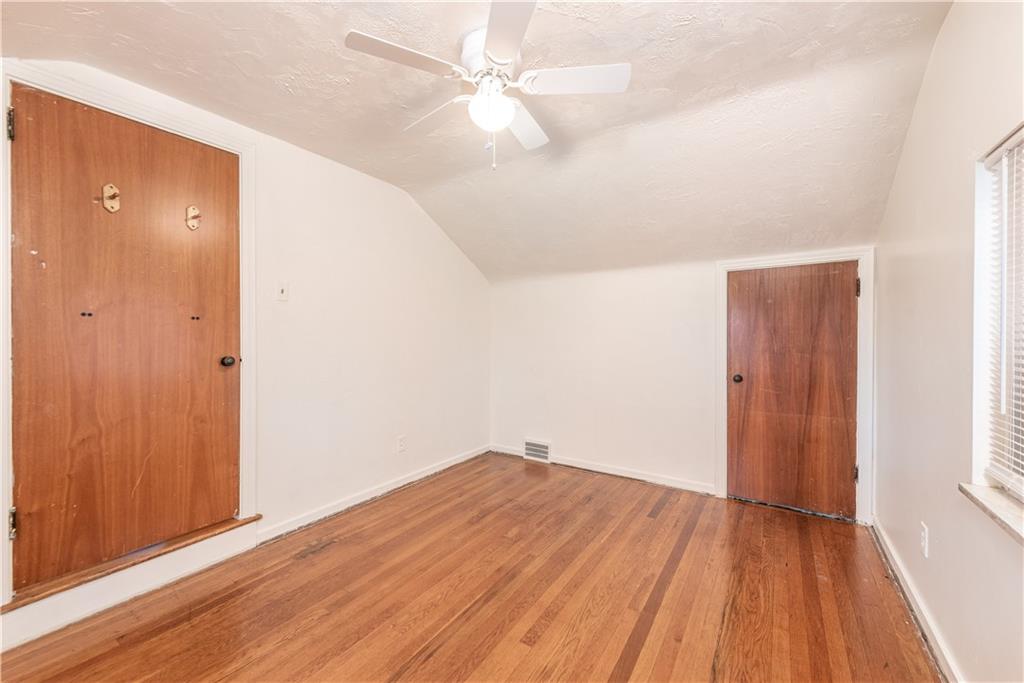 340 Spring Valley Road Pittsburgh, PA 15243 - Photo 26 of 44 an empty room with wooden floor and fan