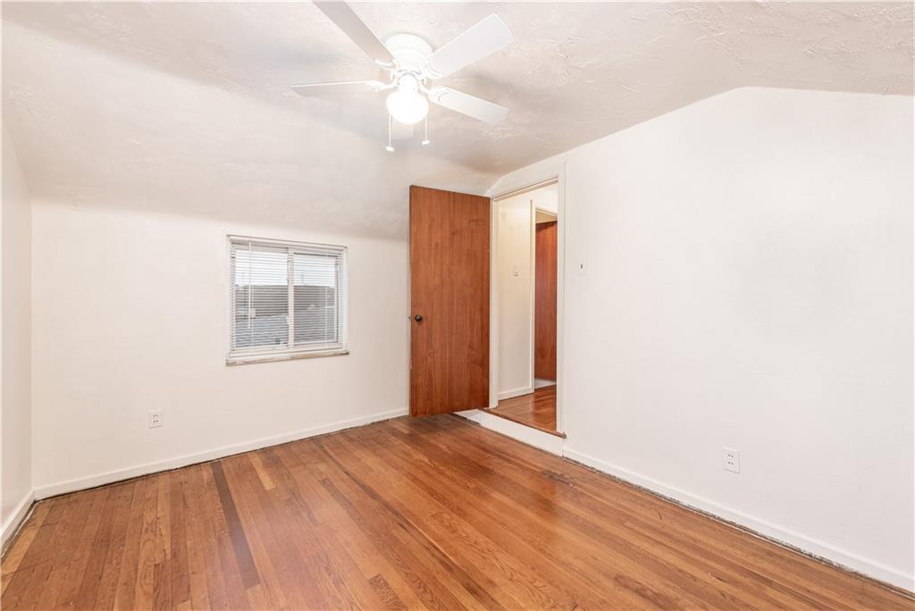 340 Spring Valley Road Pittsburgh, PA 15243 - Photo 27 of 44 an empty room with wooden floor fan and windows