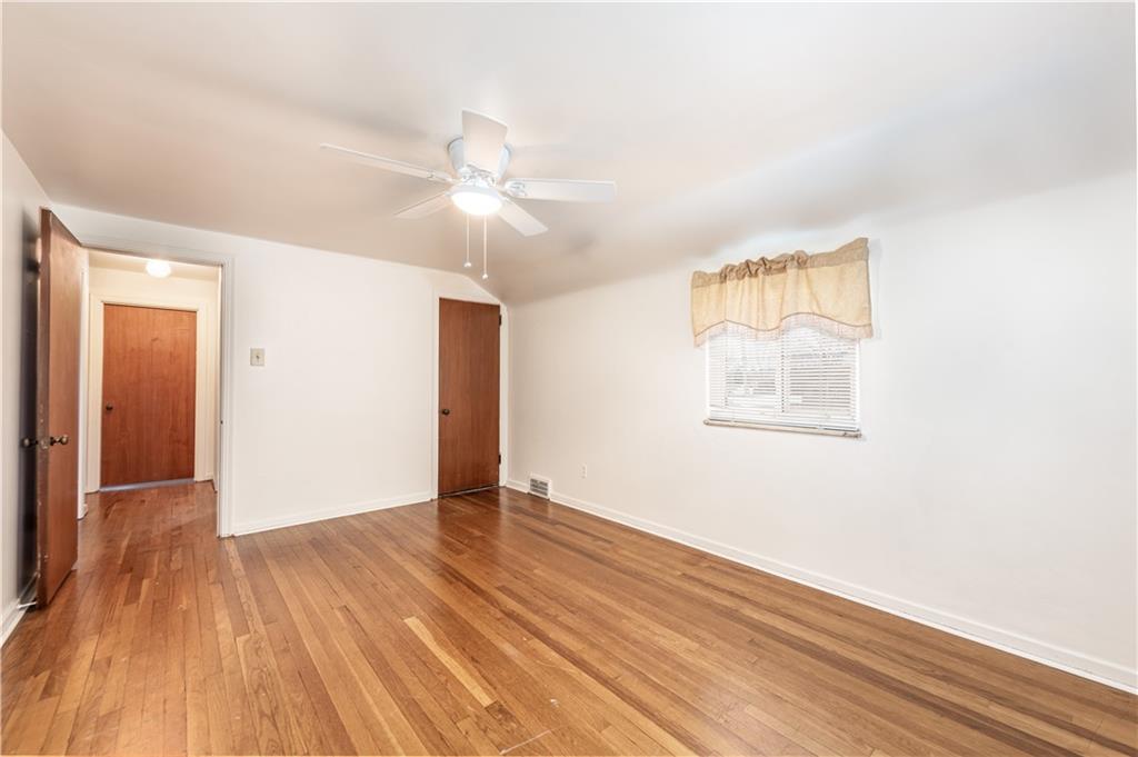 340 Spring Valley Road Pittsburgh, PA 15243 - Photo 31 of 44 an empty room with wooden floor chandelier fan and windows