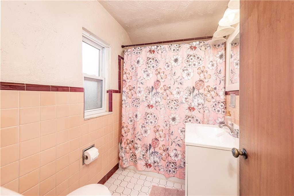 340 Spring Valley Road Pittsburgh, PA 15243 - Photo 32 of 44 a bathroom with a shower curtain and a toilet