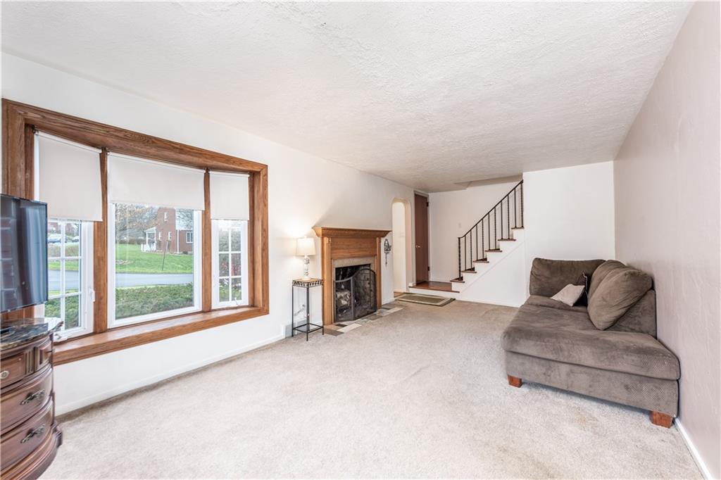 340 Spring Valley Road Pittsburgh, PA 15243 - Photo 6 of 44 a living room with furniture and a fireplace