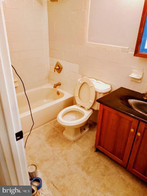 9110 Meadow Heights Road Randallstown, MD 21133 - Photo 16 of 21 a bathroom with a sink toilet and shower
