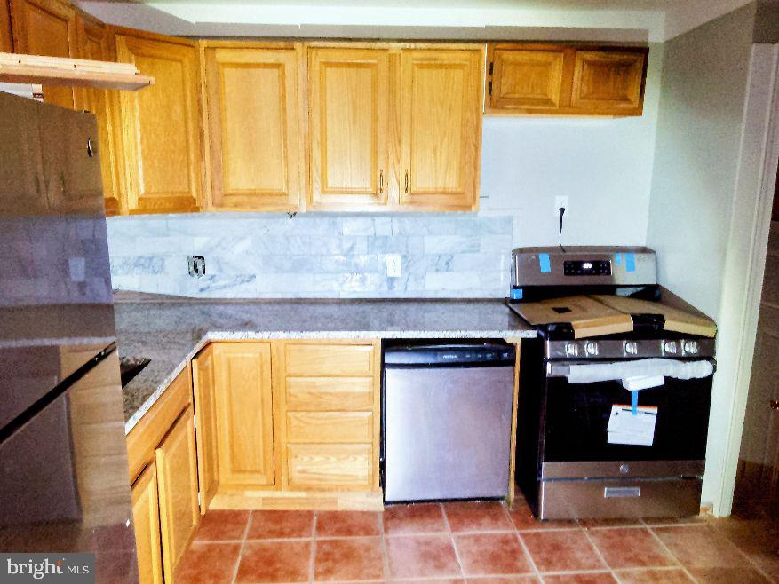 9110 Meadow Heights Road Randallstown, MD 21133 - Photo 2 of 21 a kitchen with stainless steel appliances granite countertop a sink and a cabinets