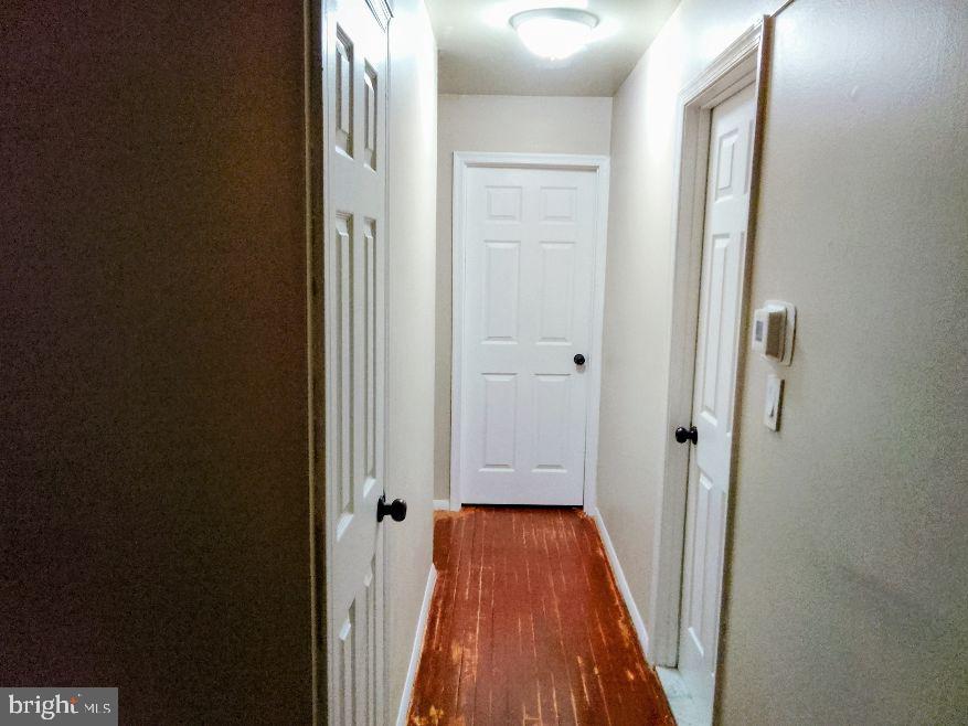 9110 Meadow Heights Road Randallstown, MD 21133 - Photo 3 of 21 a view of a hallway with wooden floor