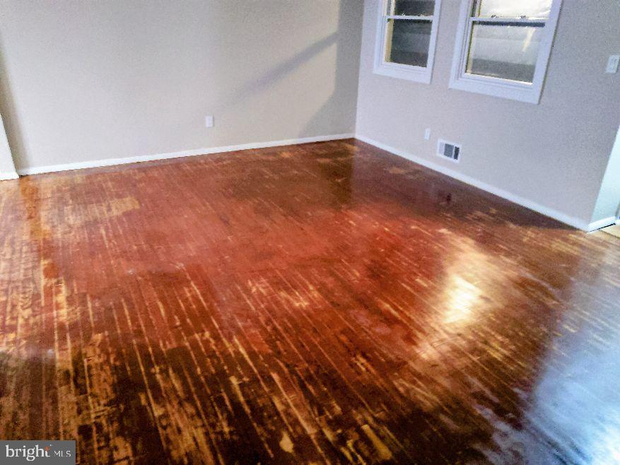 9110 Meadow Heights Road Randallstown, MD 21133 - Photo 5 of 21 a view of empty room with wooden floor