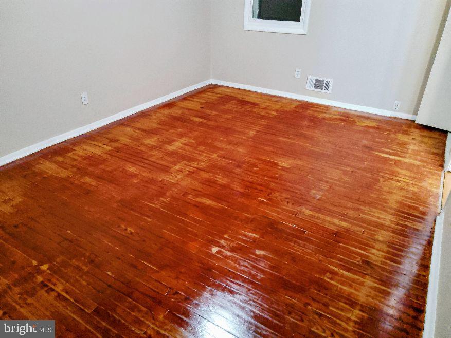 9110 Meadow Heights Road Randallstown, MD 21133 - Photo 6 of 21 a view of empty room with wooden floor