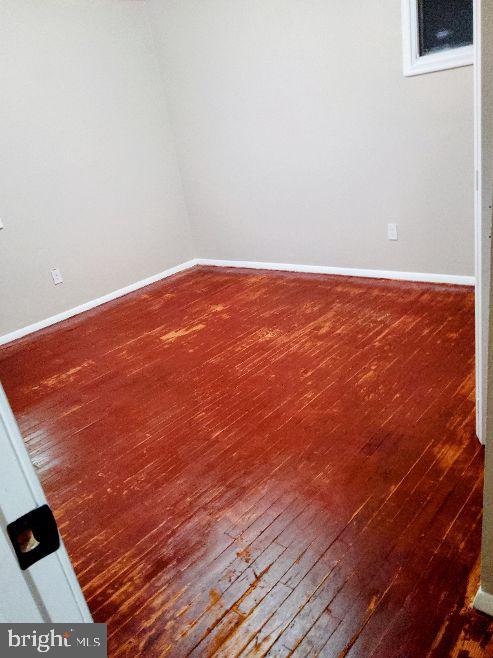 9110 Meadow Heights Road Randallstown, MD 21133 - Photo 8 of 21 a view of an empty room with wooden floor and a window